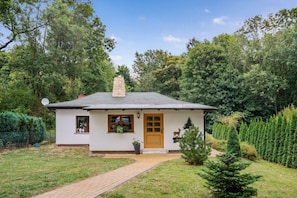 A small white house with a brown door, a chimney, and a satellite dish. - ||---------------------"Haus Waldesruh"------------------|| (Elbingerode)