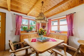 A wooden interior with a table, chairs, and a hanging light fixture. - ||---------------------"Haus Waldesruh"------------------|| (Elbingerode)