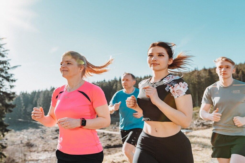 A group of people jogging outdoors.