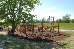A playground with a climbing structure and a bicycle parked nearby. - Type 2 in the Schwardt house (Kellenhusen)