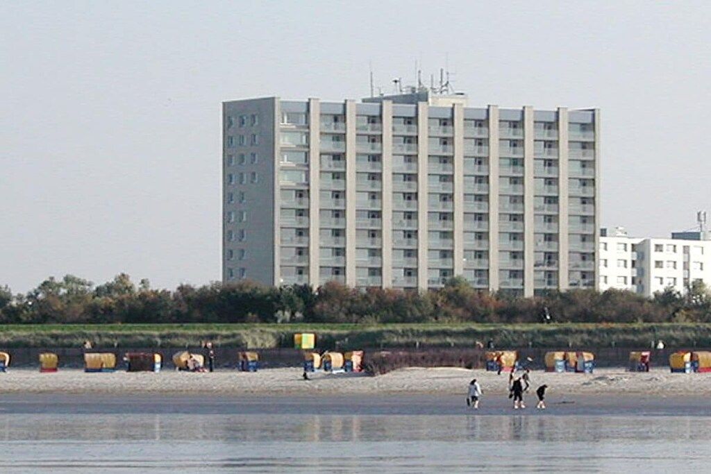 A high-rise building with multiple floors, a flat roof, and a uniform facade.
