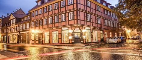 A traditional European building with a symmetrical facade, multiple windows, and a central entrance.