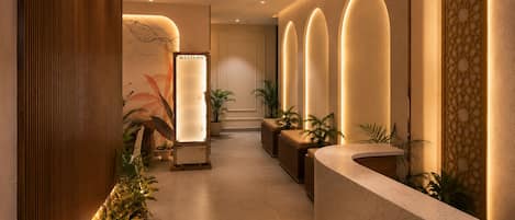A hotel reception area with a wooden reception desk, a wall-mounted sign labeled 'WESTERN', and a reception counter with a sign reading 'RICH'.