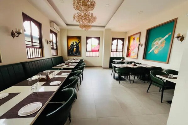 A restaurant with multiple dining tables and booths, arranged in a spacious layout.