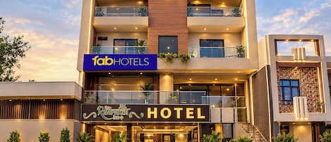 A multi-story hotel with a prominent sign for 'fabHOTELS' and 'The RudraSh HOTEL'.