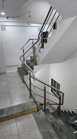 A staircase with metal railings leading to an upper floor.
