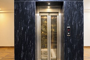 An elevator with a metallic interior and a digital display showing the number 3.
