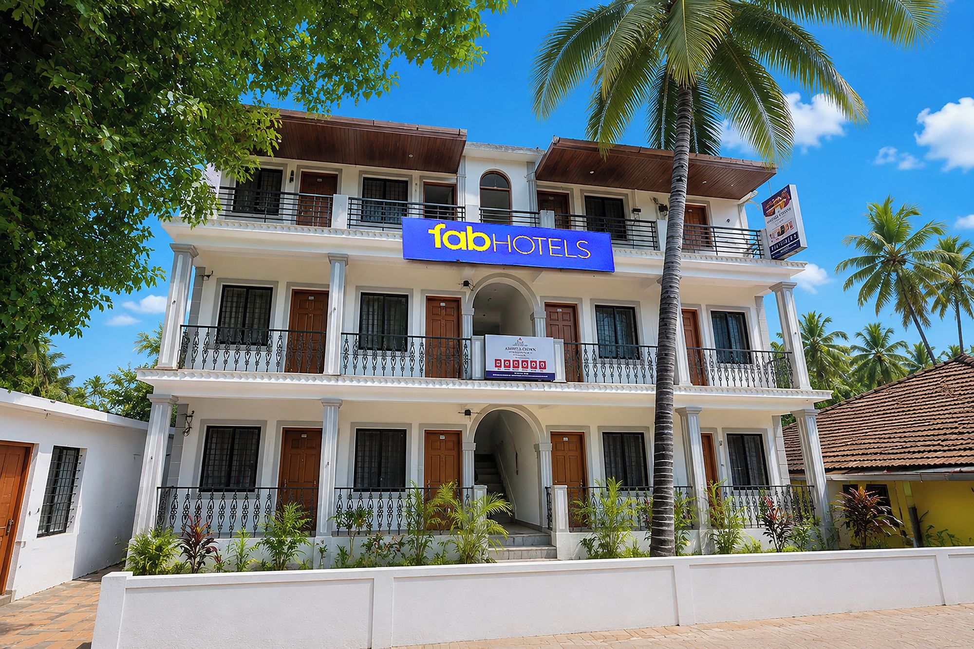 A multi-story hotel with a prominent sign for 'fabHOTELS'.