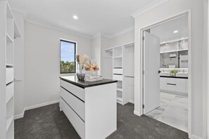 A modern bathroom with a marble countertop, a sink, and a mirror. - Luxury Corner New Home | Central AC | 4 Ensuites | Total 5.5 BH (Tāmaki Makaurau)
