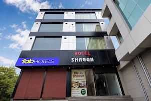 A modern hotel facade with a prominent 'Tab Hotels' sign and 'Hotel Shagun' branding.
