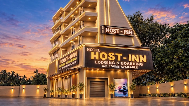 A hotel with multiple floors, a prominent sign indicating it is a Host-Inn, and a clear view of the entrance. - Fabhotel Host Inn (Mumbai)
