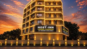 A multi-story hotel named 'HOST- INN' with a sign indicating 'LODGING & BOARDING A/C ROOMS AVAILABLE'. - Fabhotel Host Inn (Mumbai)