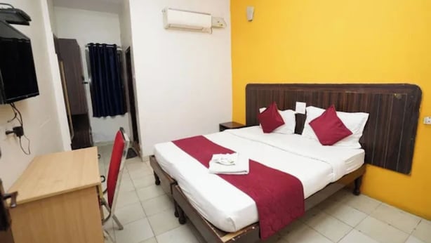 A hotel room with a bed, a desk, a chair, and a television. - Fabhotel Regal I (Hyderabad)