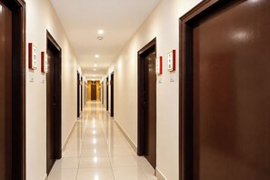 A hotel hallway with doors numbered 1 to 8, leading to rooms. - FabHotel Regal I (Hyderabad)