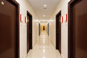 A hotel hallway with doors numbered 1 to 8, leading to individual rooms. - FabHotel Regal I (Hyderabad)