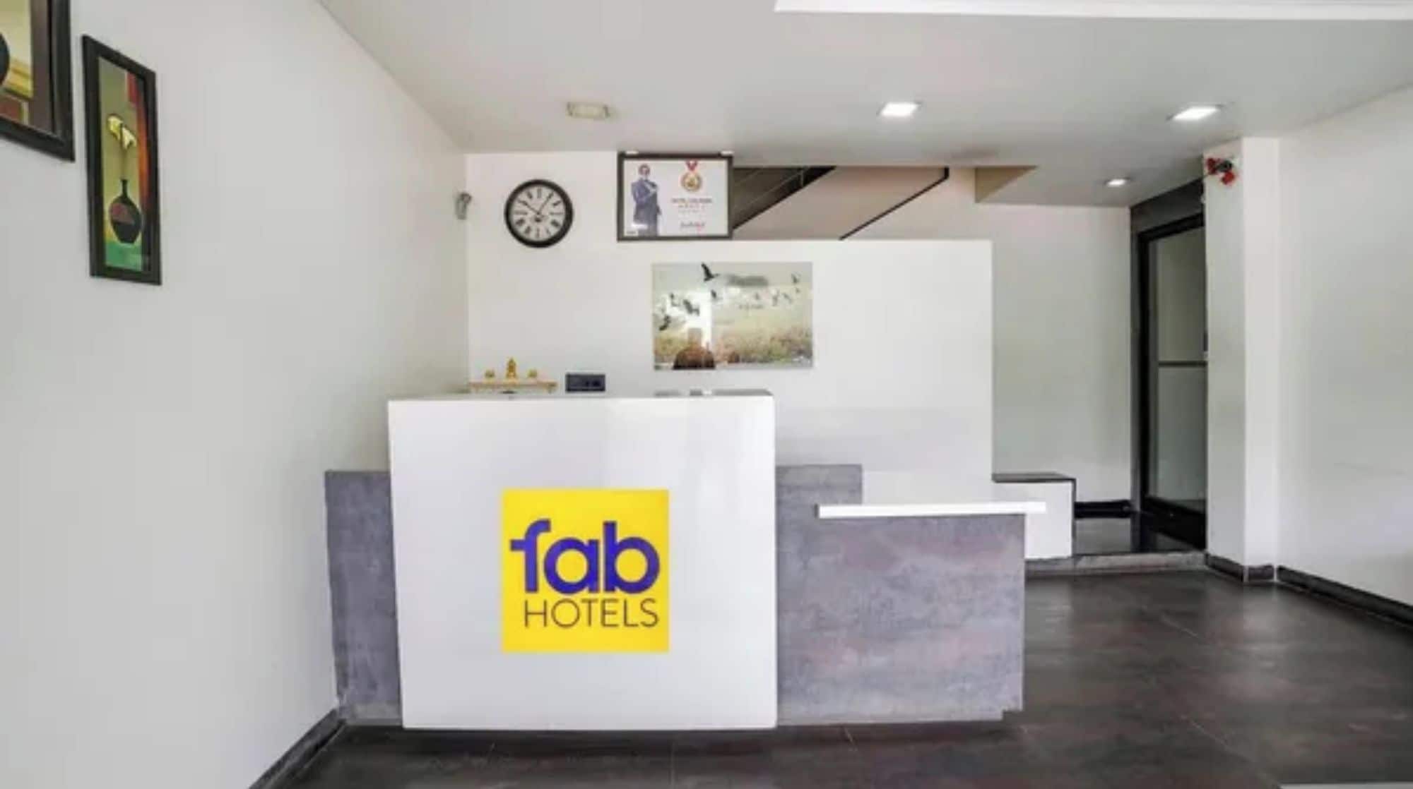 A reception desk with a logo for 'fab hotels'.