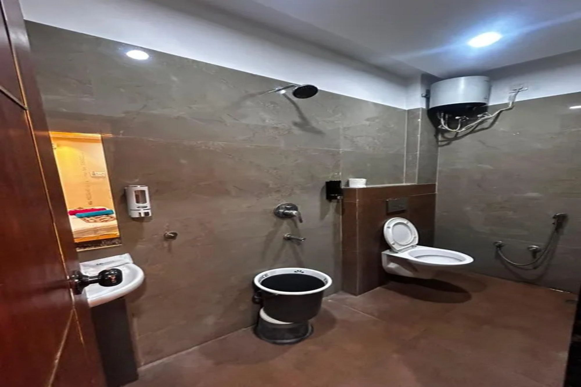 A modern bathroom with a toilet, bidet, and shower.