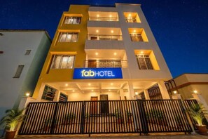 A multi-story building with a prominent 'fabHOTEL' sign at the entrance.