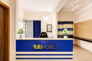 A hotel reception desk with a sign reading 'fabHOTEL'.