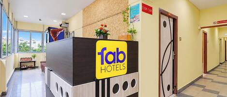 A hotel reception desk with a sign reading 'fab hotels'.