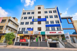 A multi-story building with a prominent 'Tab Hotels' sign. - FabHotel Living Tree Suites (Hyderabad)