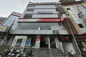 A multi-story building with a gym, a cafe, and a hotel named 'Hero'. - Fabhotel Cozi Inn (Gurugram)