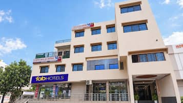 A multi-story hotel with balconies, a visible entrance, and signage for 'Hotel Eka Inn Lodging' and 'Tab Hotels'.