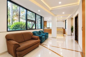 A modern reception area with a sofa, chairs, and a reception desk.