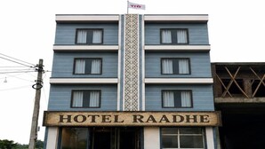 A multi-story building with a sign reading 'HOTEL RAADHE' at the entrance. - Fabhotel Raadhe (Khatoo)