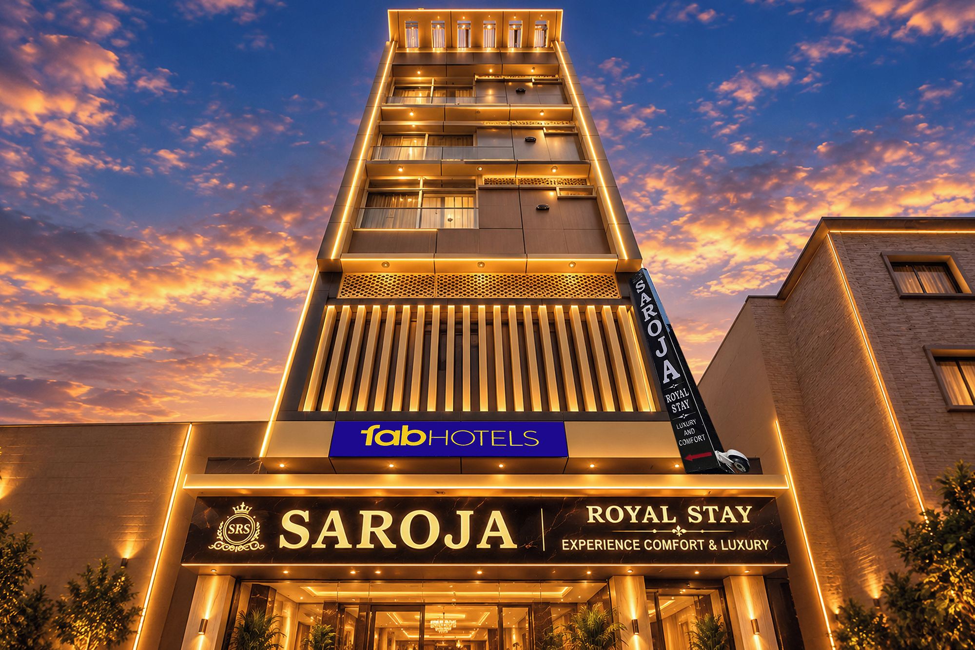 A hotel with a prominent 'Saroja Royal Stay' sign, indicating a luxury experience.