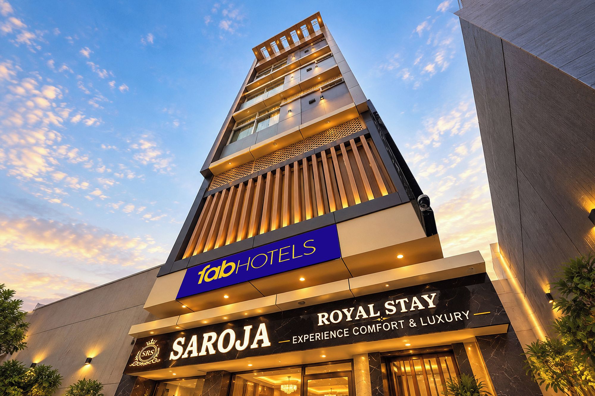 A hotel building with a prominent sign for 'fab hotels' and 'royal stay' indicating a focus on comfort and luxury.