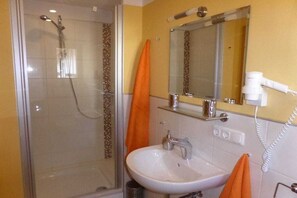 A bathroom with a glass-enclosed shower, a sink, and a mirror. - Holiday apartment in Vöhl with swimming pool (Vöhl)