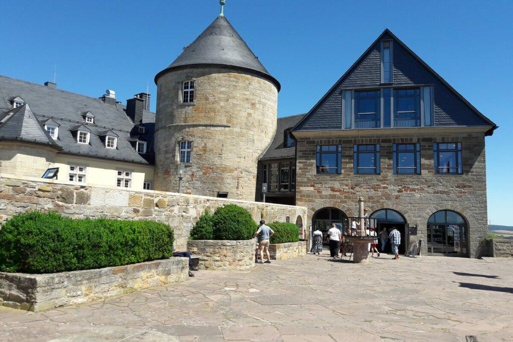 A historic stone building with a tower and a large entrance.