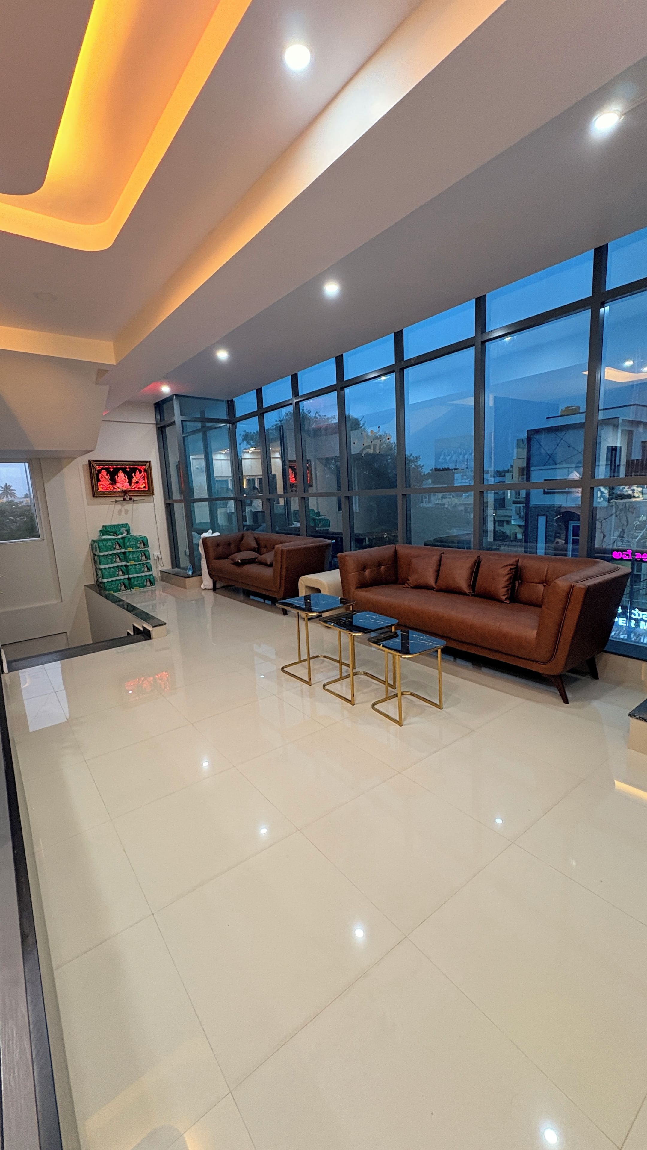A spacious lobby with a large window, a sofa, and a coffee table.