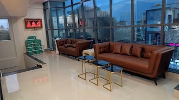 A spacious lobby with a large window, a sofa, and a coffee table.
