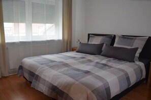 A bedroom with a bed, curtains, and a window. - Holiday home in Hülben with swimming pool (Hülben)