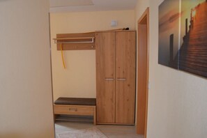 A room with a wooden wardrobe, a bench, and a painting on the wall. - Holiday home in Hülben with swimming pool (Hülben)