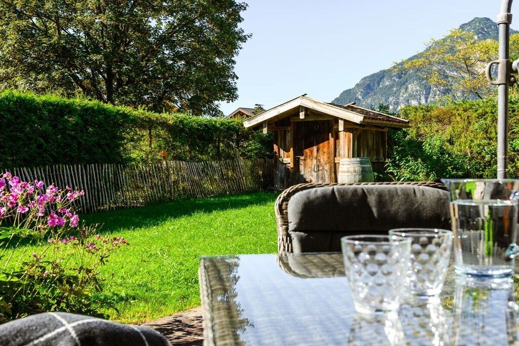 Ein Essbereich mit Tisch, Stühlen und Blick auf einen Berg.