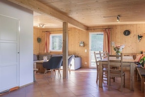 A wooden interior with a dining area, a sofa, and a table. - Cabin in Annaberg with swimming pool (Annaberg)