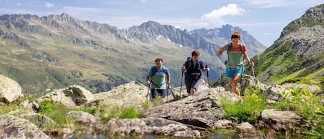 A mountainous landscape with hikers on a rocky path.