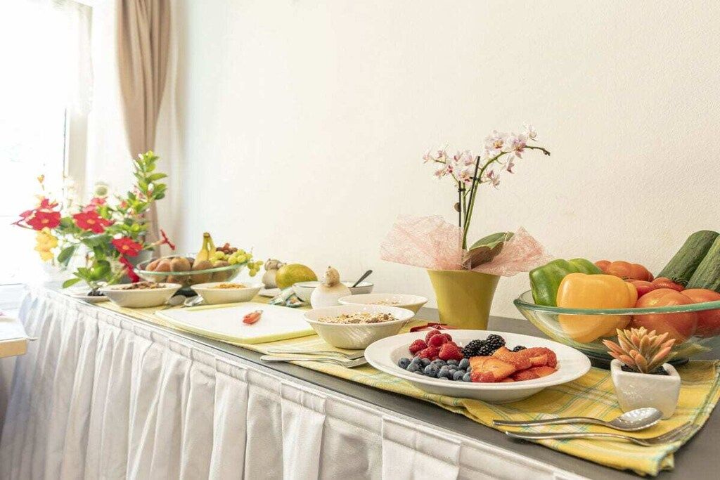 Ein Frühstücksbuffet mit verschiedenen Früchten, Gemüse und Getreideprodukten.