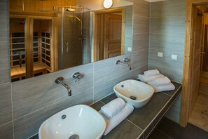 A modern bathroom with two sinks, a large mirror, and a shower enclosure. - Cabin in Annaberg with swimming pool (Annaberg)