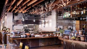 A bar area with a central counter, various food items, and a selection of bottles. - Unparalleled Luxury and Family Adventure at The Ritz-Carlton Club- 4 Bd. Res (Truckee)