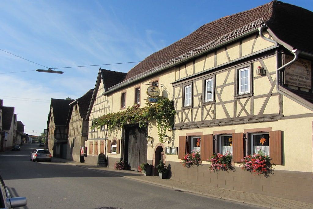 A traditional half-timbered building with a sign indicating a restaurant.
