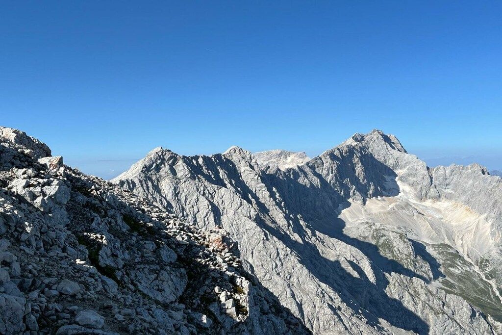 A mountainous landscape with rocky terrain and a clear sky.