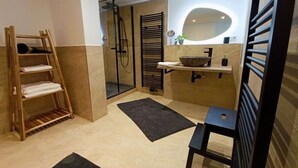 A modern bathroom with a wooden shelf, a large mirror, and a black towel rack. - Bergstadthaus Sankt Andreasberg (St. Andreasberg)