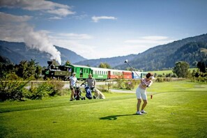 A golf course with a train in the background. - Apartment with 1 bedroom (St. Georgen am Kreischberg)