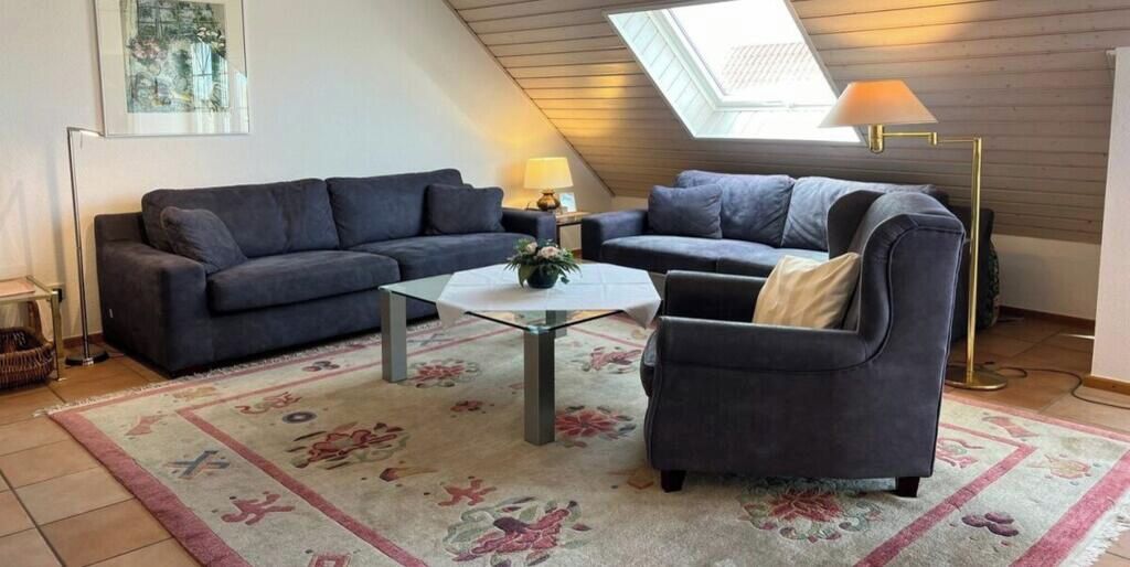 A living room with two sofas, a coffee table, and a lamp.