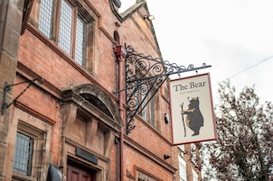 A building with a sign reading 'The Bear' and a bear silhouette.