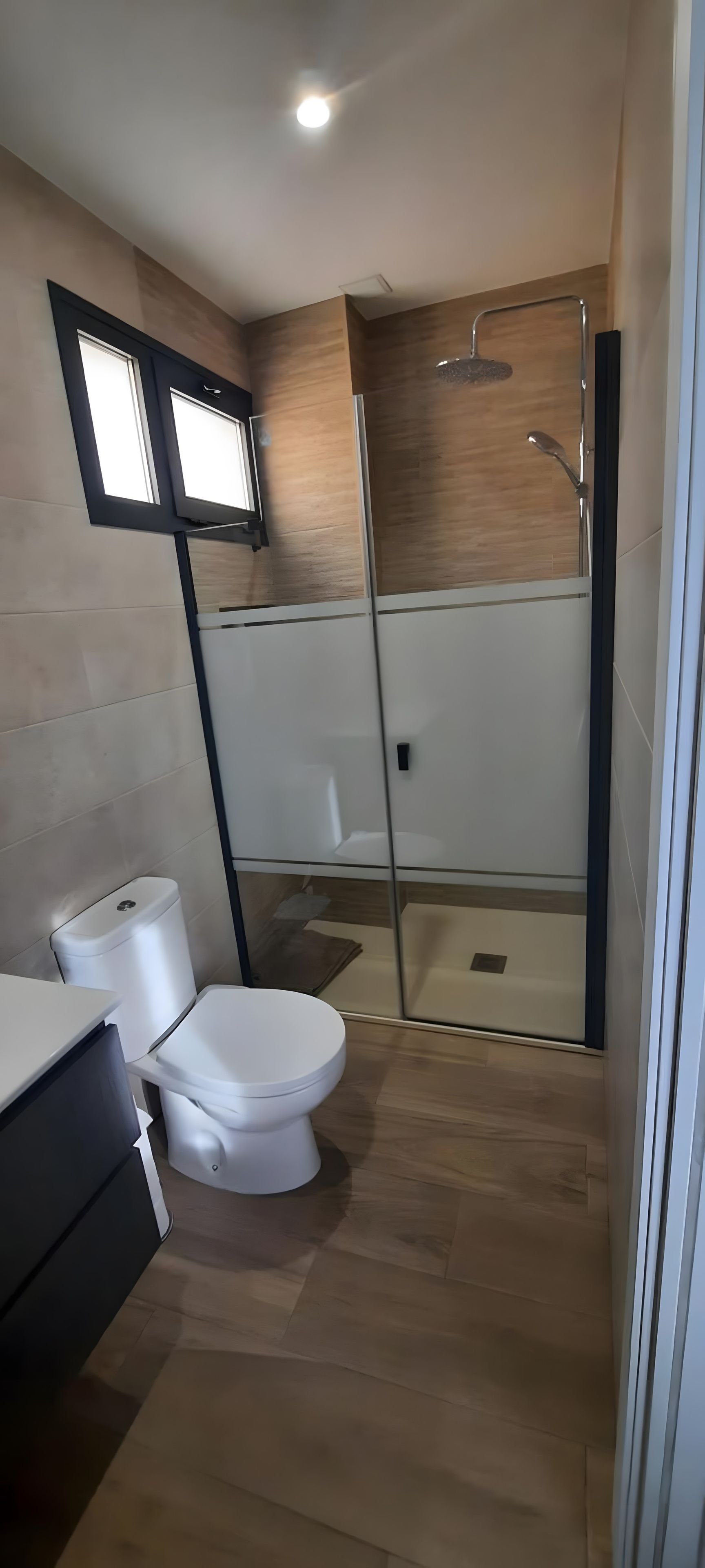 A modern bathroom with a toilet, bidet, and shower.